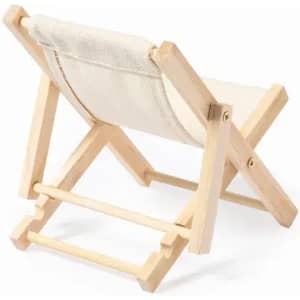 A folding chair made of wood with a beige canvas seat and backrest, showcasing a minimalist design.