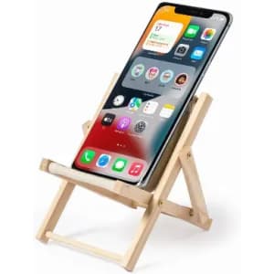 A phone stand made of wood, holding a smartphone in a vertical position with a bright screen displayed.