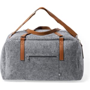 A grey felt duffel bag with brown leather straps and a front zippered pocket. The bag has a minimalist design and a logo.