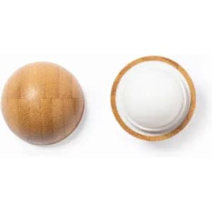A wooden ball-shaped product with a smooth white centre, featuring a natural textured finish.