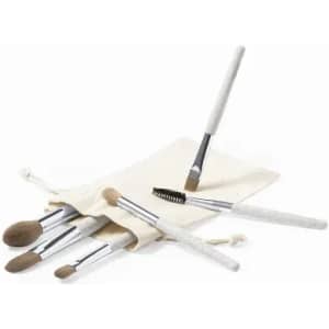 A brush set with various makeup brushes in a cream-coloured fabric pouch. The brushes feature silver handles.