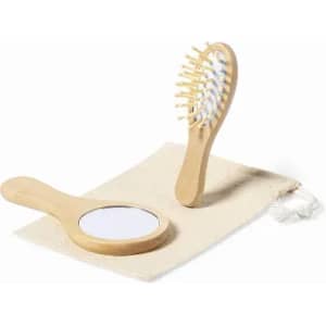 A wooden hairbrush and mirror set on a light-coloured fabric pouch. The brush has a natural finish.