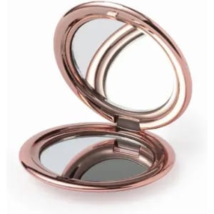 A rose gold compact mirror with a hinged lid, featuring two reflective surfaces inside.