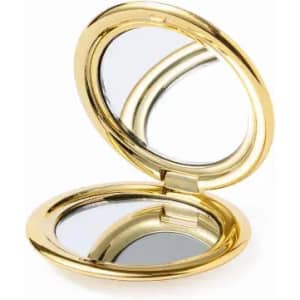 A gold compact mirror with a shiny finish, opened to reveal two reflective surfaces inside.
