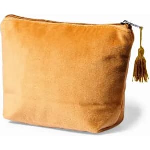 A pouch in a warm orange hue with a textured surface and a zip closure, featuring a decorative tassel.