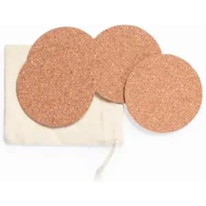 A set of four round cork coasters in a small drawstring bag. The coasters are light brown and textured.