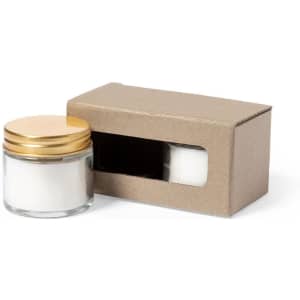 A glass jar with a gold lid containing white product, displayed in a cardboard box with a window.