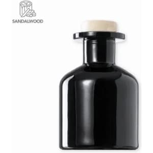A drink bottle in a sleek black design with a cream-coloured cap. It features a logo on the side.
