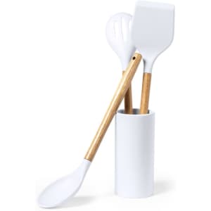 A utensil holder containing three white kitchen utensils with wooden handles.