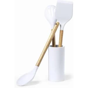 A utensil holder containing three white kitchen tools with wooden handles. The holder is white.