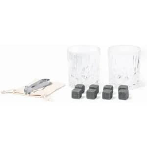 A drink set featuring two crystal glasses, six soapstone ice cubes, and a serving pouch with a tongs.