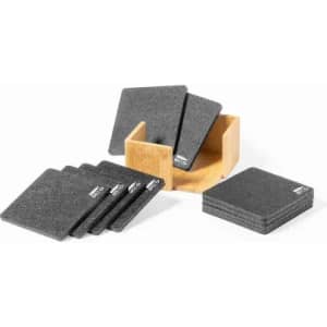 A set of square grey coasters displayed with a wooden holder. The coasters have a simple design and a logo.