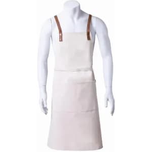 A cream-coloured apron with leather straps and front pockets, displayed on a mannequin.