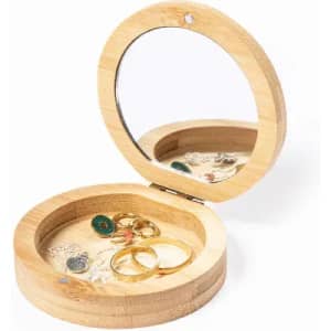 A round bamboo jewellery box with a mirror inside, showcasing rings and earrings. The box is light brown in colour.