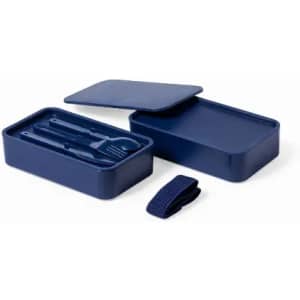 A navy blue lunch box set with a lid, containing utensils and a strap for securing it.