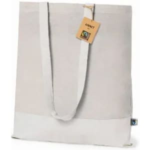 A Fairtrade tote bag in light grey with white accents, featuring shoulder straps and a tag.