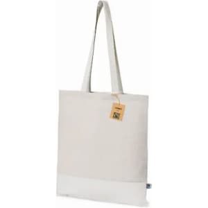 A tote bag in a light cream colour with a white bottom and long straps, featuring a small tag.