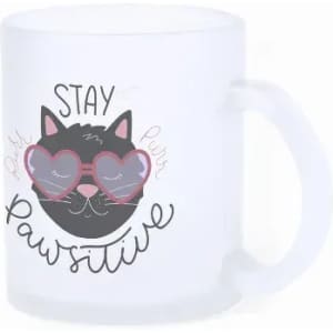 A frosted mug featuring a cat design with sunglasses and the phrase "Stay Pawsitive." It has a handle and a logo.