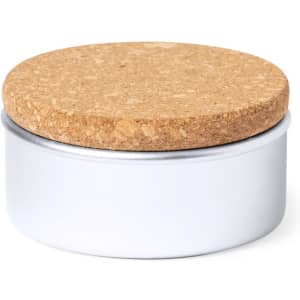 A round storage tin with a silver base and a cork lid. The design is simple and minimalistic.