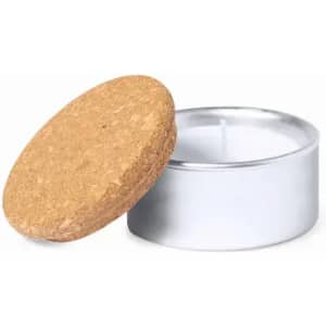 A candle in a silver tin with a cork lid. The tin is shiny and the cork lid is textured and round.