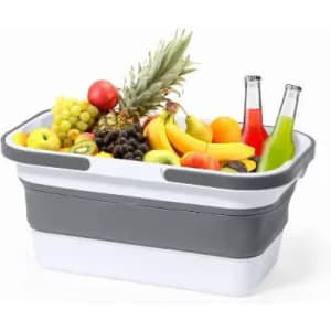 A fruit basket filled with various fruits and two bottles of colourful beverages, featuring a grey and white design.