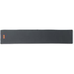 A grey yoga mat with a smooth texture and an orange logo on one end.