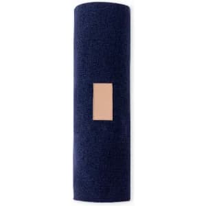 A yoga mat in navy blue with a textured surface and a rectangular patch. It has a simple, modern design.