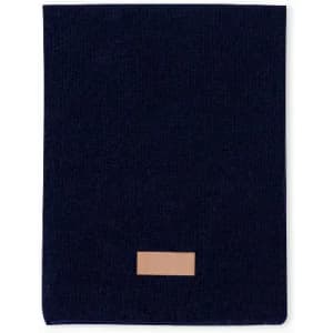 A navy blue fabric item with a tan leather patch, featuring a simple, minimalist design.