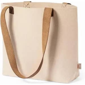 A tote bag in cream with brown leather handles and a simple design, featuring a logo on the side.