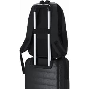A black backpack with adjustable straps positioned on top of a rolling luggage piece, featuring a sleek design.