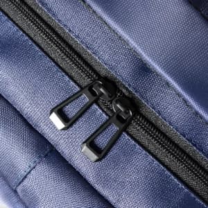 A zippered closure on a navy blue fabric bag, featuring dual black zipper pulls.