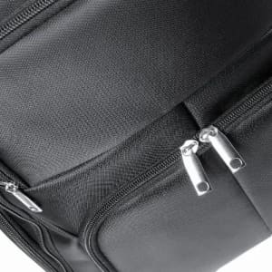A black backpack with multiple zipped compartments and a textured fabric pattern.