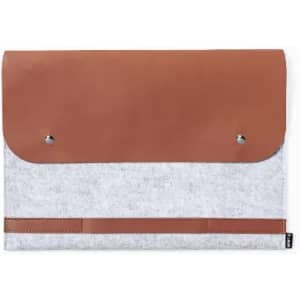 A laptop bag featuring a grey felt body with a brown leather flap and metallic studs for closure.