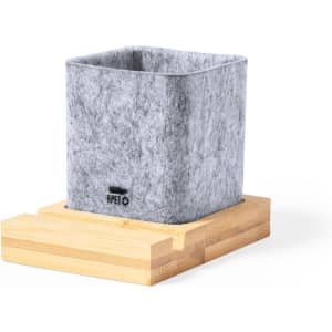 A square grey felt planter resting on a light wooden base, featuring a branding logo.
