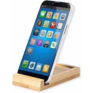 A smartphone displayed on a wooden stand, featuring a variety of app icons on its screen. The stand has a natural finish.