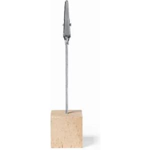 A wooden block with a metallic clip attached by a thin cable, forming a simple display stand.