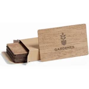A set of wooden coasters in a cardboard holder, featuring a floral logo on the front. The coasters are a natural wood colour.