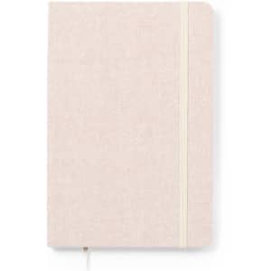 A notebook in a light beige colour with a cream elastic band closure. Features a textured cover.