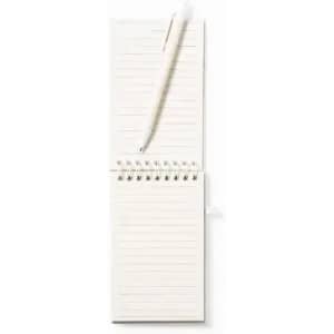 A notepad with lined pages lies open next to a white pen, resting on a flat surface.