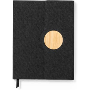 A notebook featuring a dark grey fabric cover, a wooden circle detail, and a black ribbon bookmark.