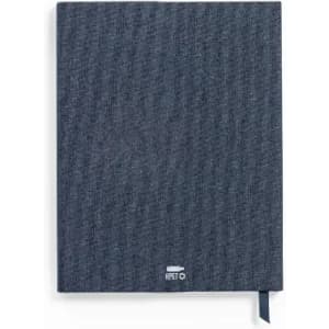 A notebook with a textured dark grey cover and a ribbon bookmark, featuring a logo at the bottom.