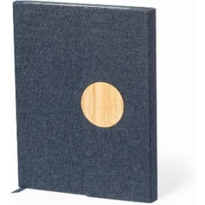 A notebook with a dark blue fabric cover and a circular bamboo accent on the front, featuring a ribbon bookmark.