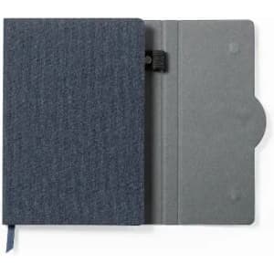 A notebook with a dark blue fabric cover, featuring an elastic closure and an interior pocket.