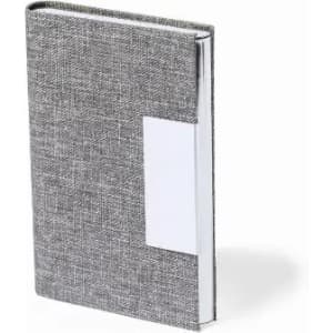 A grey notebook with a textured cover and a white label area on the front. It has a textured finish.