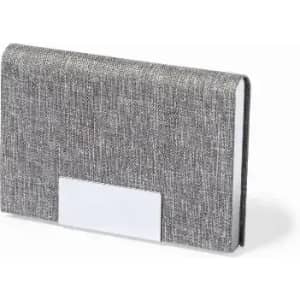A grey textured notebook with a plain white label on the front, featuring a sleek design.