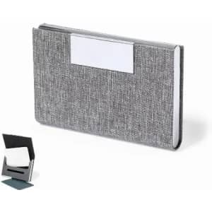 A grey business card holder with a textured fabric design and a sleek, minimalistic look. It includes a stand for display.