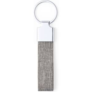 A keychain featuring a silver ring and a grey fabric strap. The design is sleek and minimalistic.