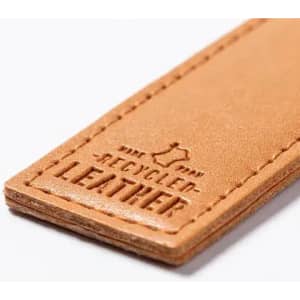 A tan leather tag with a textured finish and a logo embossed, labelled "recycled leather."