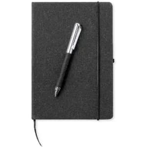 A black notebook with a matching silver pen resting on top, featuring an elastic closure and a ribbon bookmark.