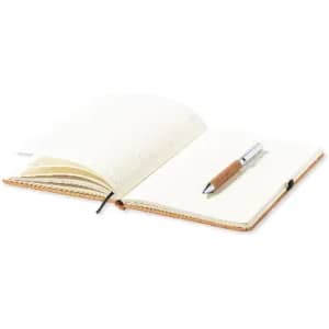 A notebook with blank pages and a silver pen resting on it, featuring a brown cork grip.